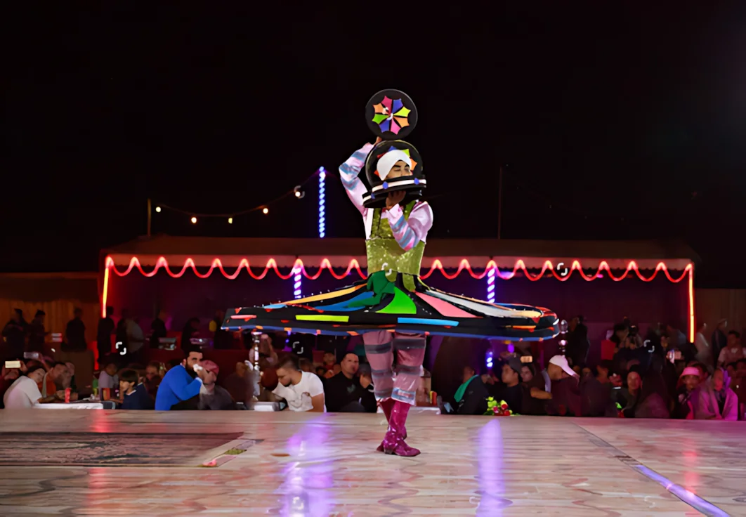 Traditional Tanoura dancer performing at a Dubai desert safari camp