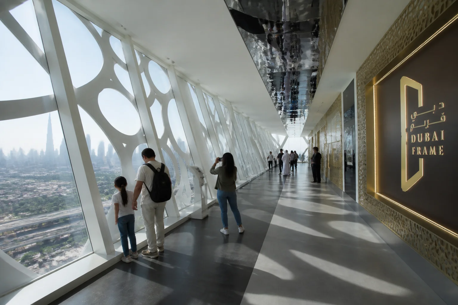 Visitors walking across the 50-meter illuminated glass skydeck bridge atop the Dubai Frame